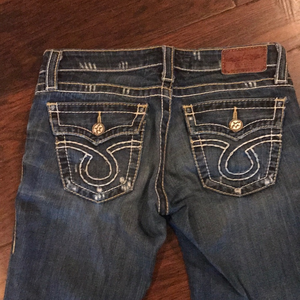 Big Star distressed boot cut jeans.